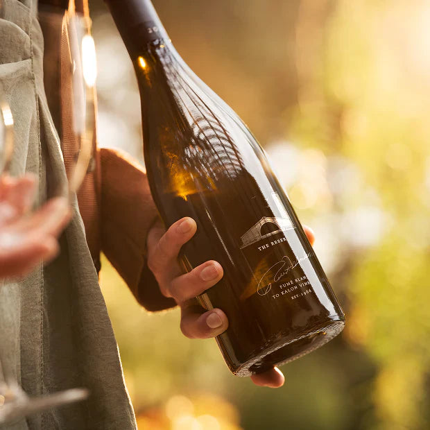 hands with a bottle and a glass